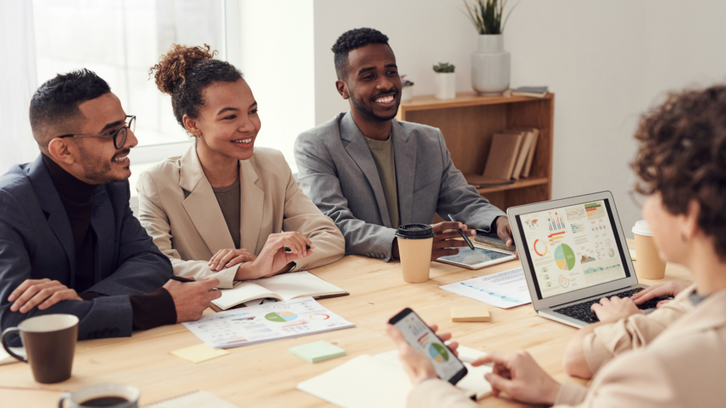 A group of happy business people sitting around a desk