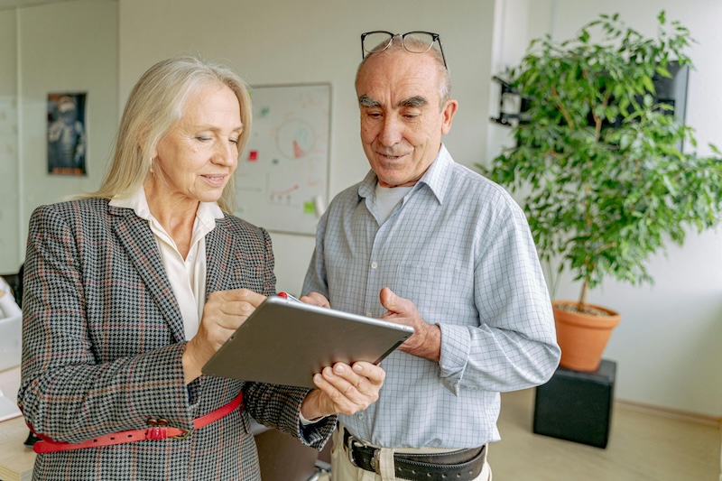 Two individuals discussing a planned giving program